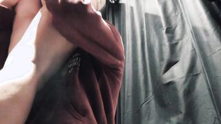 A girl with lush hair and beautiful tits gives blowjob and fucks with a guy standing in the fitting room of a store